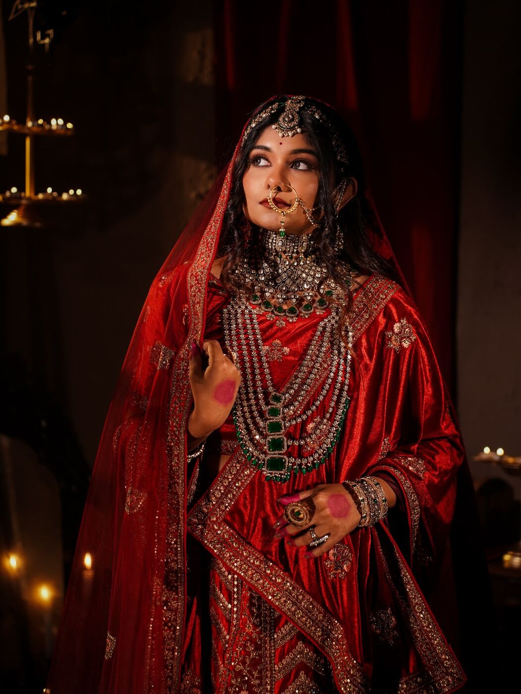 Bride in red velvet lehenga with layered kundan jewellery
