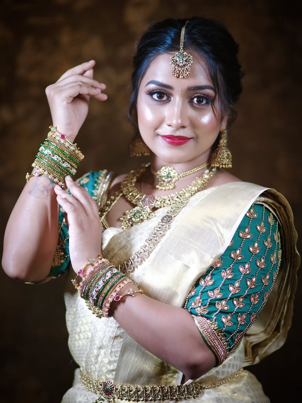 Radiant bride in cream and teal silk saree